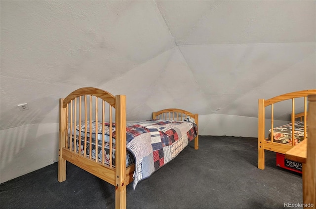 carpeted bedroom featuring vaulted ceiling