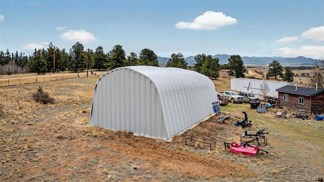view of pole building with a mountain view