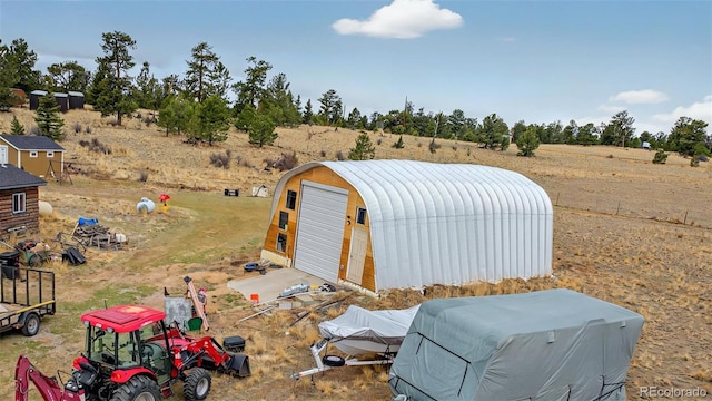 view of outbuilding featuring a rural view and an outdoor structure