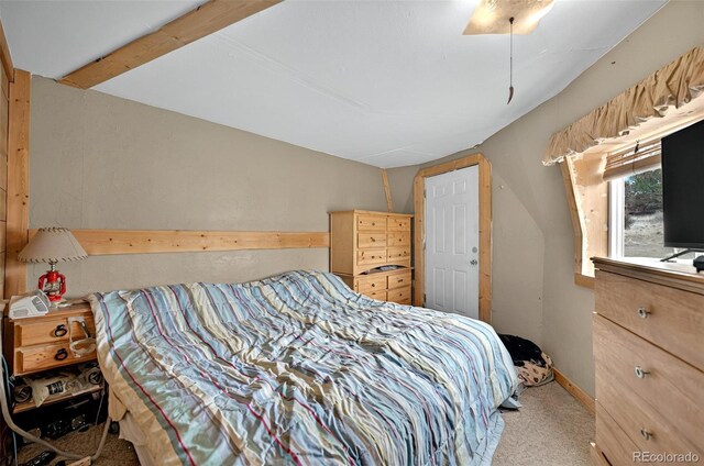 bedroom featuring carpet floors and vaulted ceiling