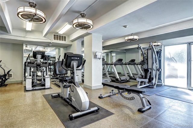 exercise room with visible vents and baseboards