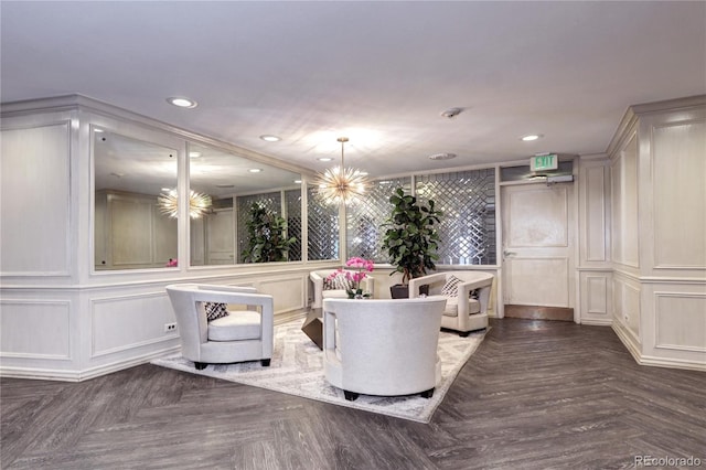 living area featuring a decorative wall and recessed lighting