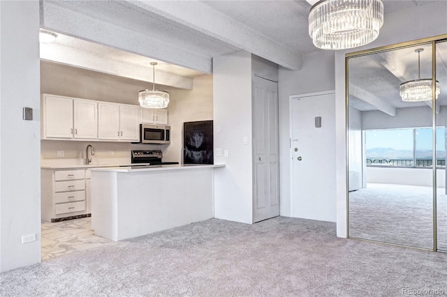 kitchen with light carpet, appliances with stainless steel finishes, a chandelier, and white cabinets