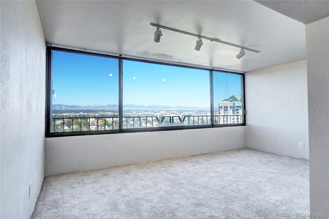 130 N Pearl St Unit 1606, Denver, CO 80203 - spare room with carpet flooring, a textured wall, and track lighting
