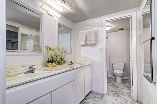 130 N Pearl St Unit 1606, Denver, CO 80203 - full bathroom with marble finish floors, toilet, and double vanity