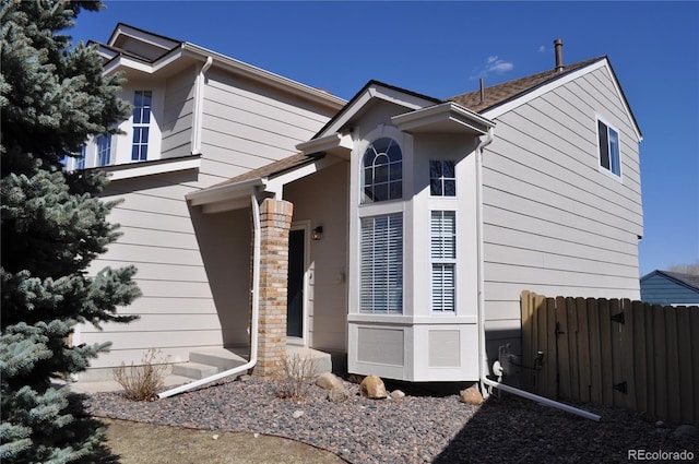 view of home's exterior featuring fence