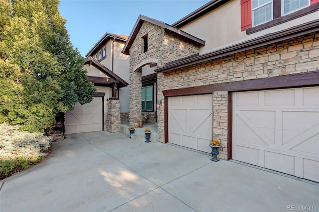5033 Silver Feather Way, Broomfield, CO 80023 - view of front facade with stone siding, driveway, and stucco siding