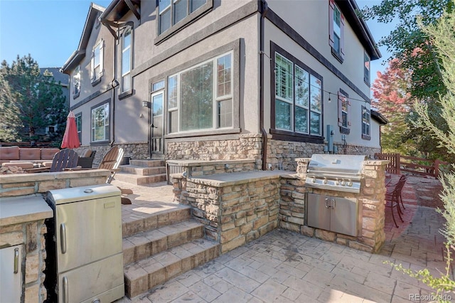 view of patio with area for grilling and exterior kitchen