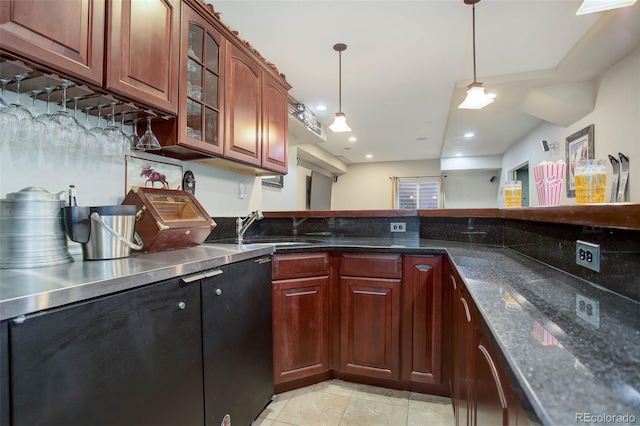 kitchen with sink, light tile patterned floors, hanging light fixtures, and dark stone counters