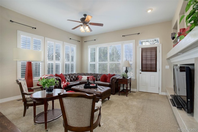 carpeted living room with ceiling fan