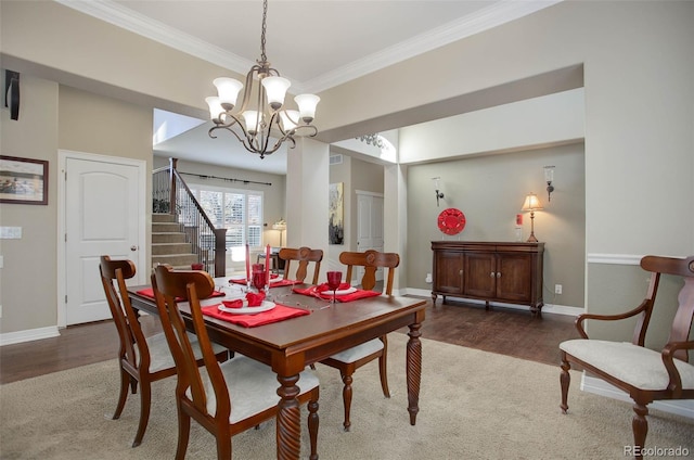 dining space featuring a notable chandelier, dark hardwood / wood-style floors, and ornamental molding