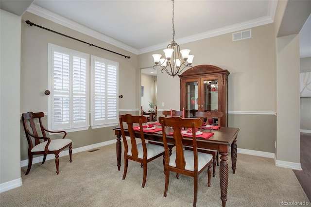 dining space with crown molding, light carpet, and a chandelier