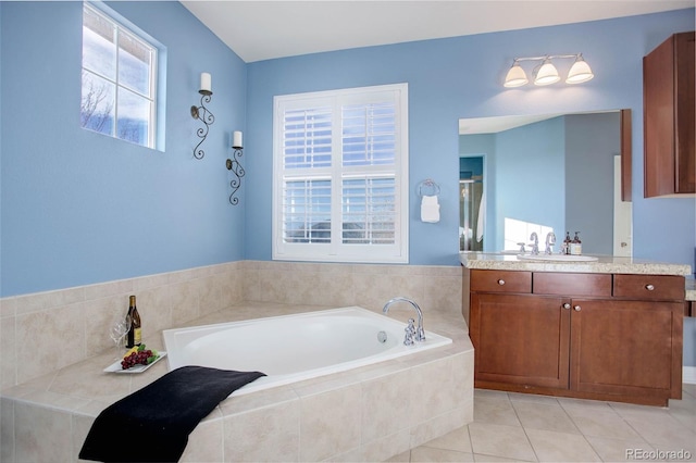 bathroom featuring tile patterned flooring, vanity, a healthy amount of sunlight, and shower with separate bathtub