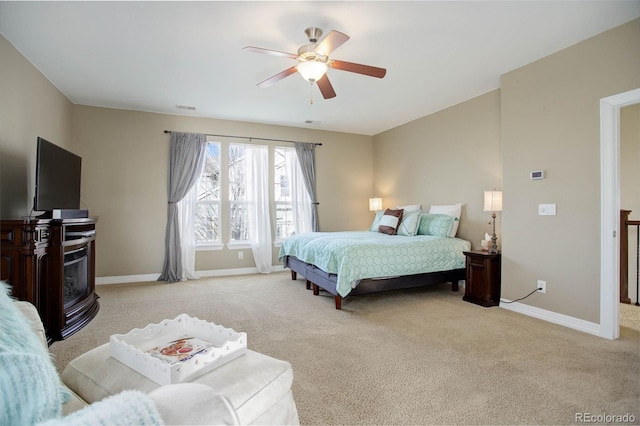 bedroom featuring ceiling fan and light carpet