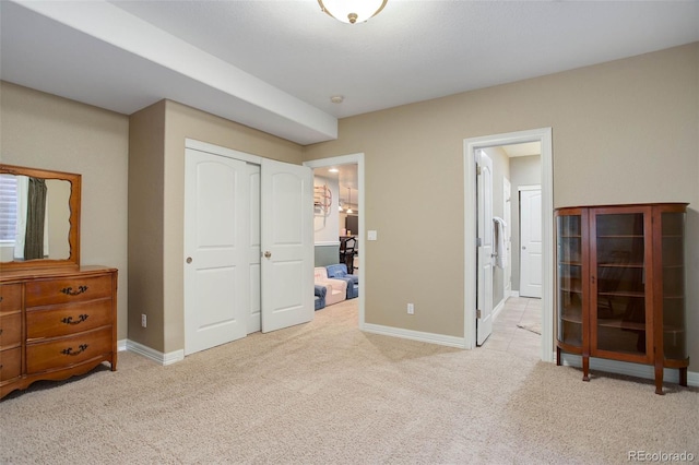 bedroom with light carpet and a closet