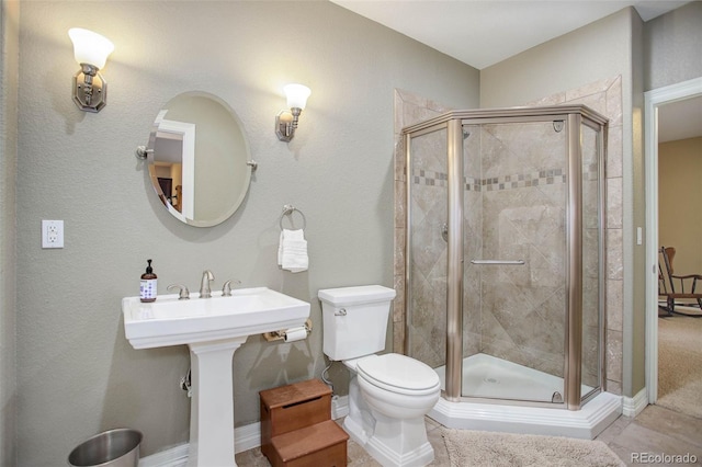 bathroom featuring an enclosed shower and toilet