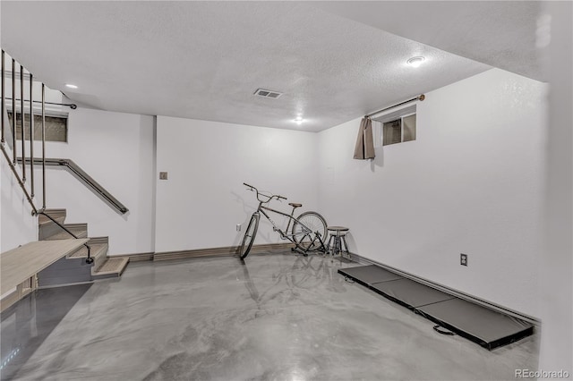 workout room with a textured ceiling