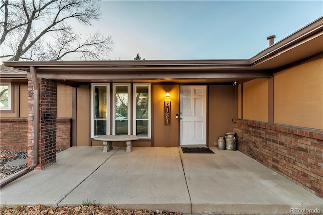 entrance to property featuring a patio