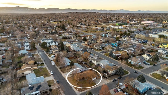 aerial view at dusk featuring a mountain view