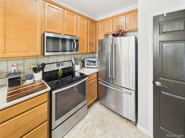 12912 Grant Cir Unit A, Thornton, CO 80241 - kitchen featuring stainless steel appliances, decorative backsplash, light countertops, and light tile patterned floors