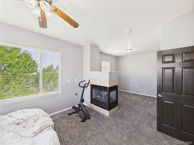 12912 Grant Cir Unit A, Thornton, CO 80241 - workout area with healthy amount of natural light, a tile fireplace, and carpet