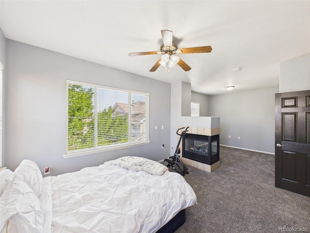 12912 Grant Cir Unit A, Thornton, CO 80241 - bedroom with carpet flooring, a tiled fireplace, and a ceiling fan
