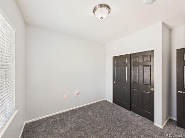 12912 Grant Cir Unit A, Thornton, CO 80241 - unfurnished bedroom with carpet, multiple windows, and a closet