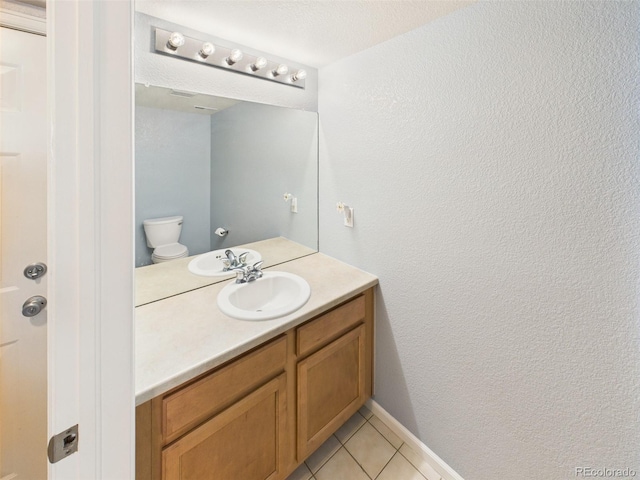 12912 Grant Cir Unit A, Thornton, CO 80241 - bathroom featuring vanity, tile patterned flooring, and a textured wall