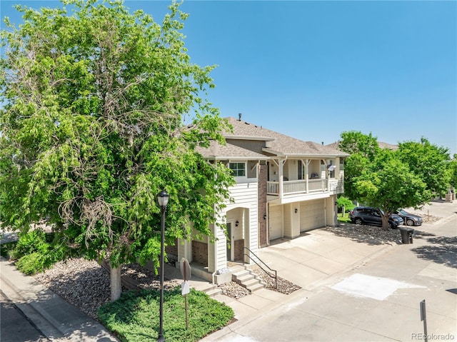 12912 Grant Cir Unit A, Thornton, CO 80241 - view of front of property with a balcony, driveway, a garage, and roof with shingles