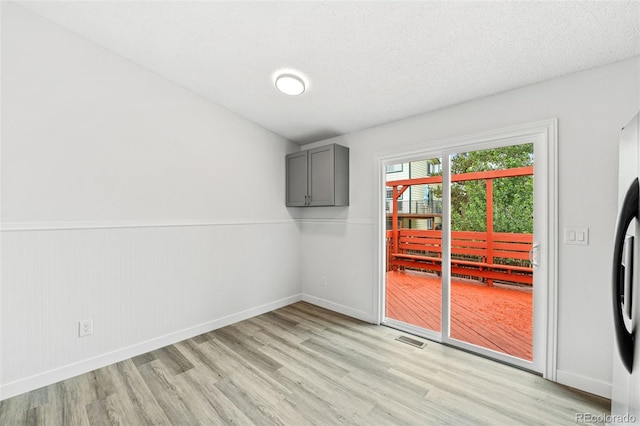 2777 S Sedalia St, Aurora, CO 80013 - unfurnished room featuring light wood-style floors and wainscoting