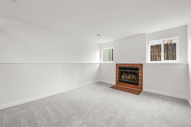 2777 S Sedalia St, Aurora, CO 80013 - unfurnished living room featuring a tile fireplace and carpet