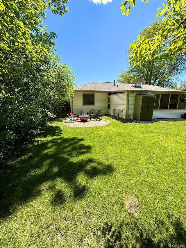 4425 E Harvard Ave, Denver, CO 80222 - rear view of property featuring a fire pit, a lawn, a sunroom, and a patio area