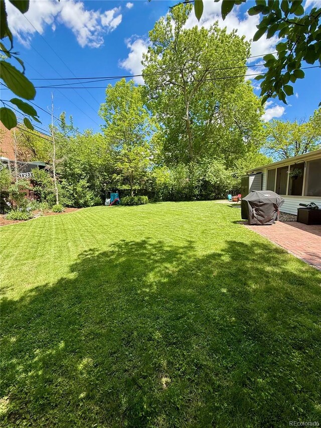 4425 E Harvard Ave, Denver, CO 80222 - view of grassy yard with a patio area and a sunroom