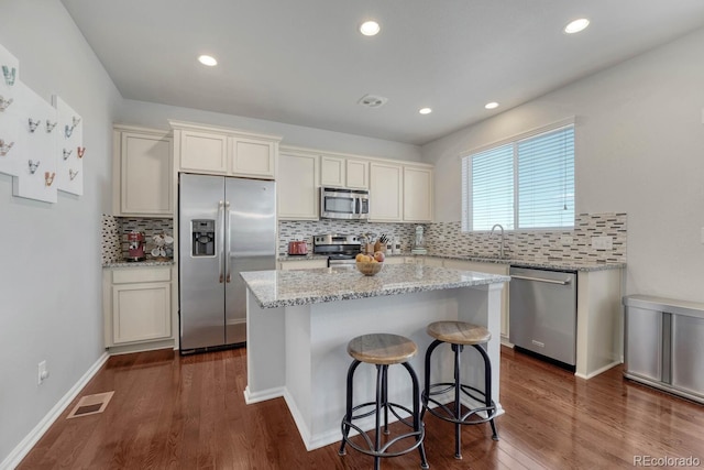 7686 Grady Cir, Castle Rock, CO 80108 - kitchen featuring appliances with stainless steel finishes, a sink, a kitchen island, backsplash, and recessed lighting