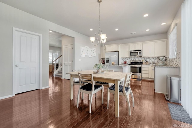7686 Grady Cir, Castle Rock, CO 80108 - dining space with dark wood-style floors, stairway, a chandelier, and recessed lighting