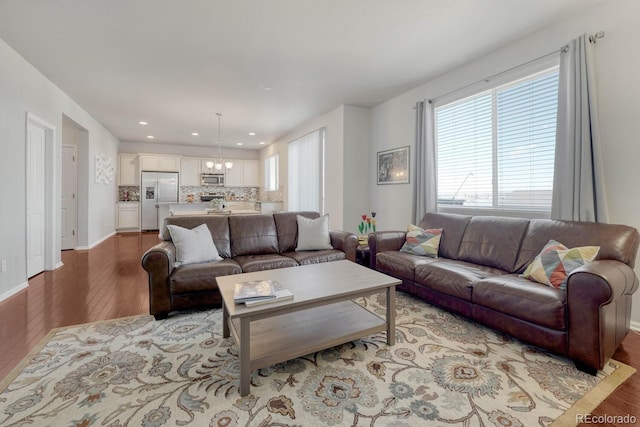 7686 Grady Cir, Castle Rock, CO 80108 - living room with light wood finished floors, a chandelier, recessed lighting, and baseboards