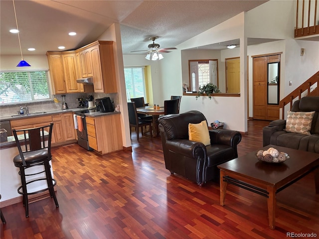 14963 E Adriatic Pl, Aurora, CO 80014 - kitchen featuring electric range, dark wood-style floors, open floor plan, plenty of natural light, and recessed lighting