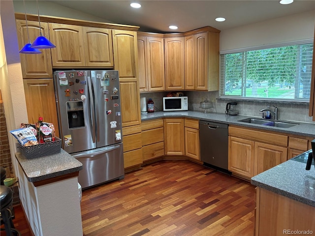 14963 E Adriatic Pl, Aurora, CO 80014 - kitchen with stainless steel appliances, wood finished floors, backsplash, recessed lighting, and pendant lighting
