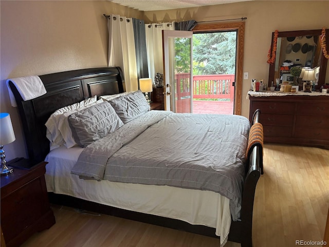 14963 E Adriatic Pl, Aurora, CO 80014 - bedroom with access to outside and wood finished floors