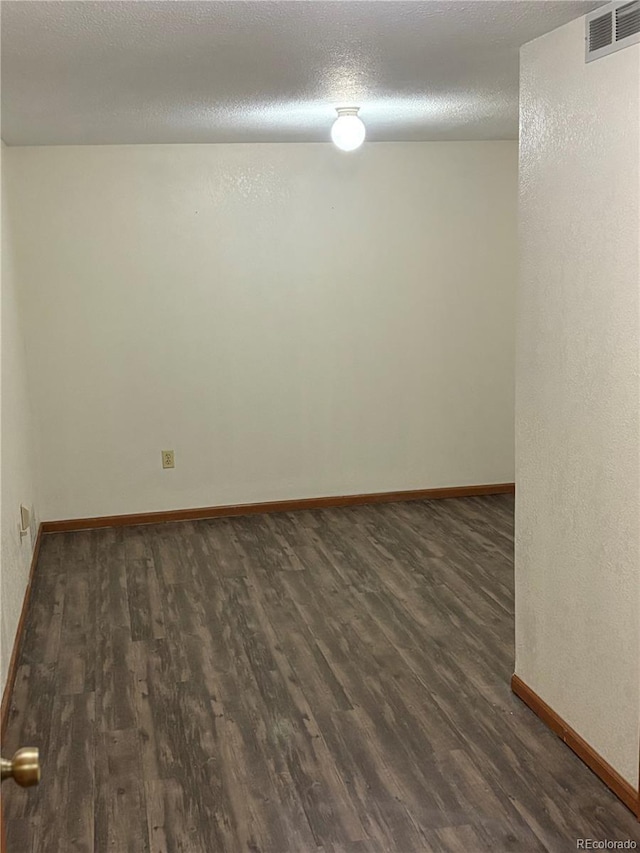14963 E Adriatic Pl, Aurora, CO 80014 - unfurnished room with dark wood-type flooring and a textured ceiling