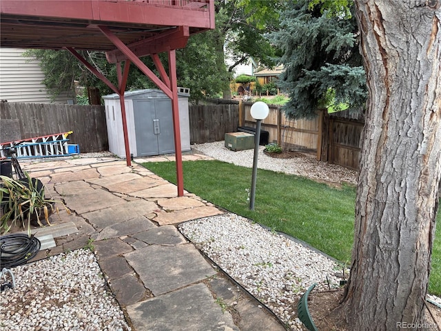 14963 E Adriatic Pl, Aurora, CO 80014 - fenced backyard featuring a storage unit and a patio area
