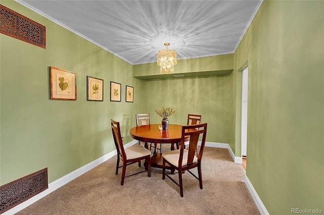 carpeted dining area featuring an inviting chandelier and crown molding