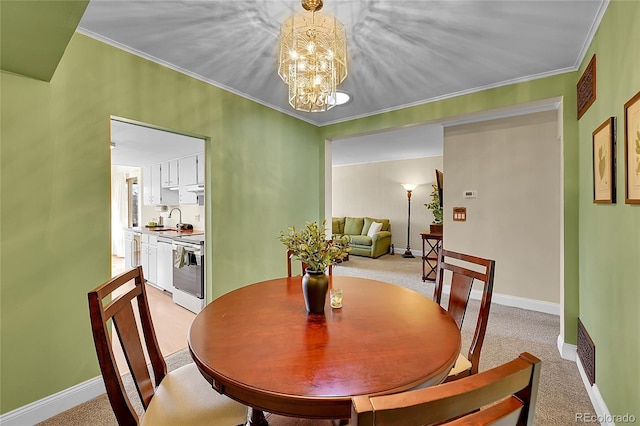 carpeted dining space featuring sink, crown molding, and a notable chandelier