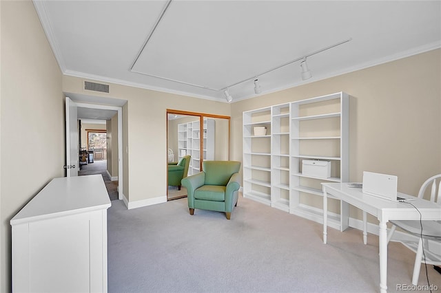 living area with track lighting, ornamental molding, and carpet flooring