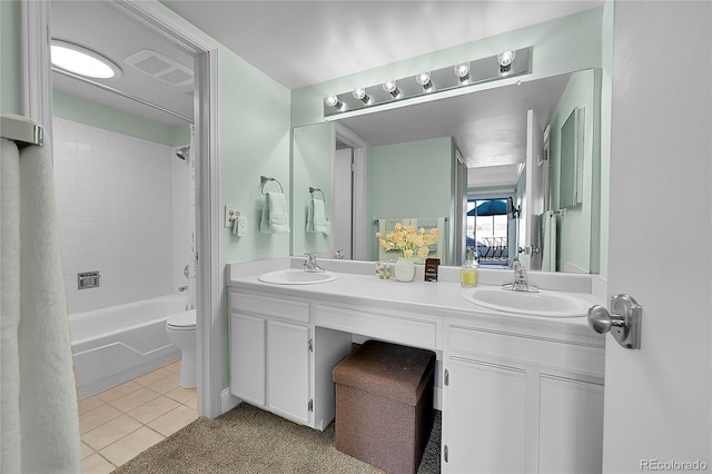 full bathroom with vanity, tiled shower / bath combo, tile patterned floors, and toilet