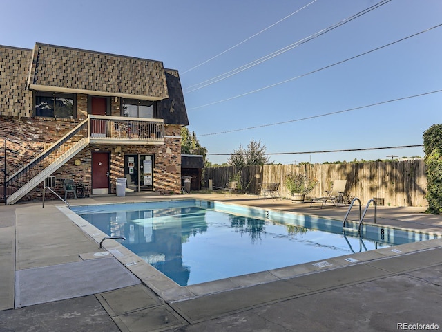 view of swimming pool with a patio area