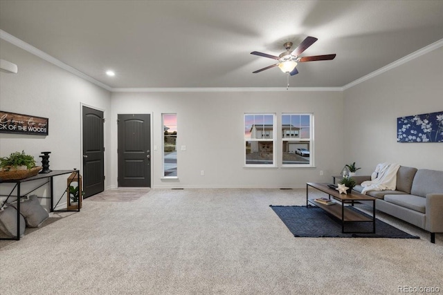 carpeted living room with ceiling fan and ornamental molding