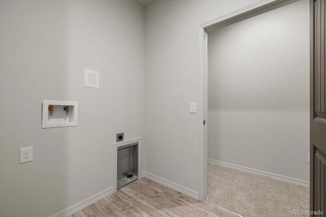 clothes washing area with light wood-type flooring, hookup for a washing machine, and electric dryer hookup