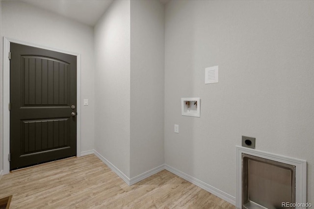 clothes washing area featuring electric dryer hookup, washer hookup, and light wood-type flooring