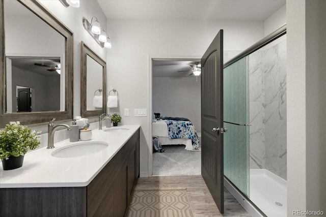 bathroom with vanity, ceiling fan, and a shower with shower door